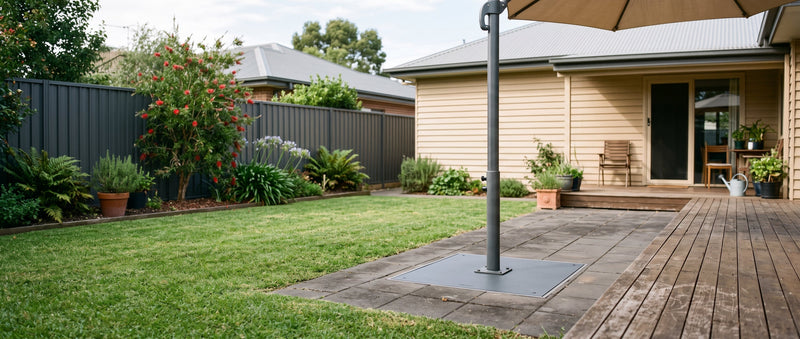 Cantilever umbrella base plate mounted flush into a paved patio