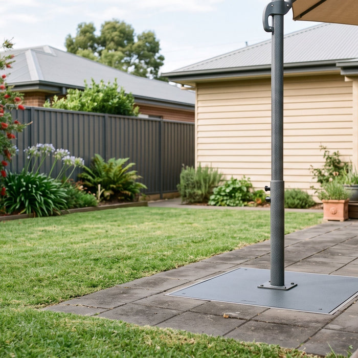 Cantilever umbrella base plate mounted flush into a paved patio