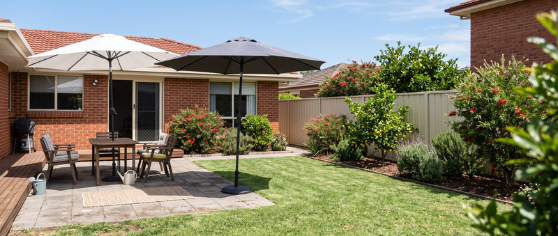 White and charcoal cantilever patio umbrellas side by side showing canopy colour contrast