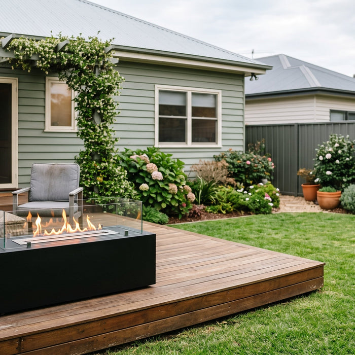 Rectangular bioethanol fire table with a linear flame on a timber deck