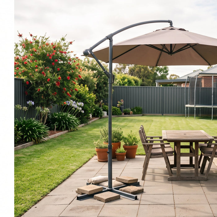Cantilever patio umbrella on a weighted base with concrete paver ballast in a tidy Australian suburban backyard