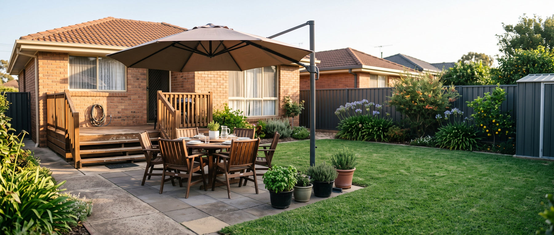Octagonal cantilever umbrella shading a dining table in a normal Australian backyard