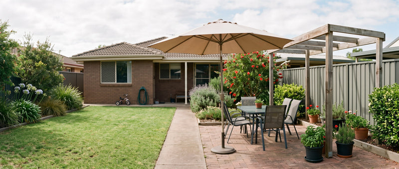 Cantilever patio umbrella over a small courtyard dining table beside a timber pergola frame