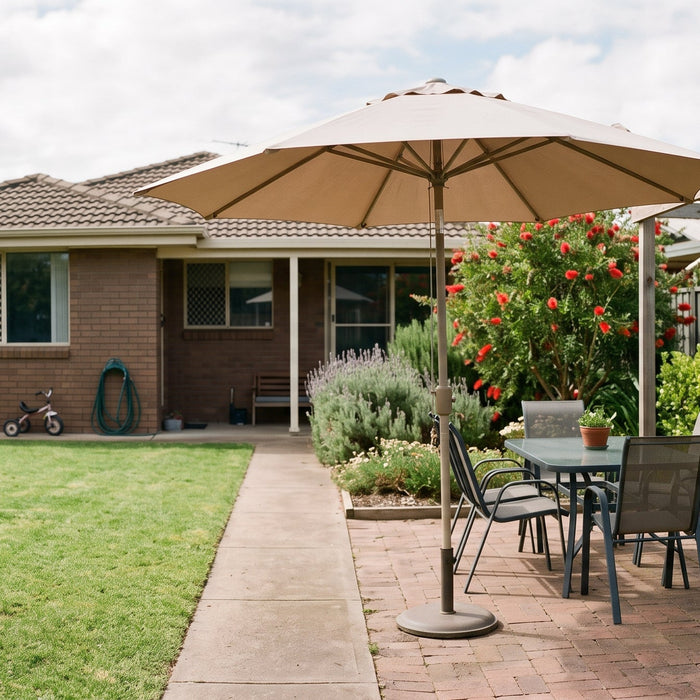 Cantilever patio umbrella over a small courtyard dining table beside a timber pergola frame