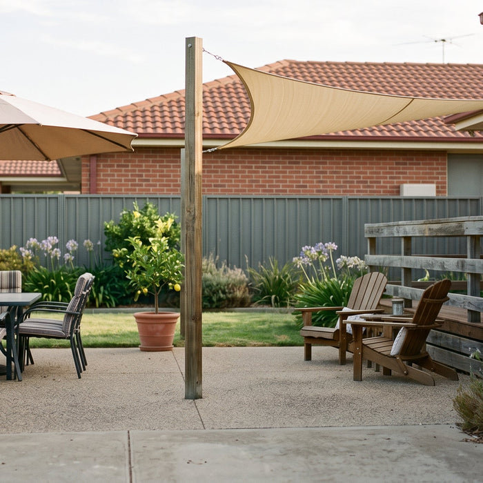 Cantilever patio umbrella and shade sail shading separate zones of a suburban paved patio