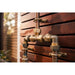 Handmade Banksia copper and brass hot and cold outdoor shower mounted against a wall.