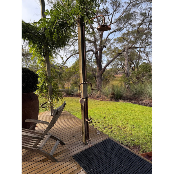 Handmade Waratah slim copper and brass hot and cold outdoor shower on a post.