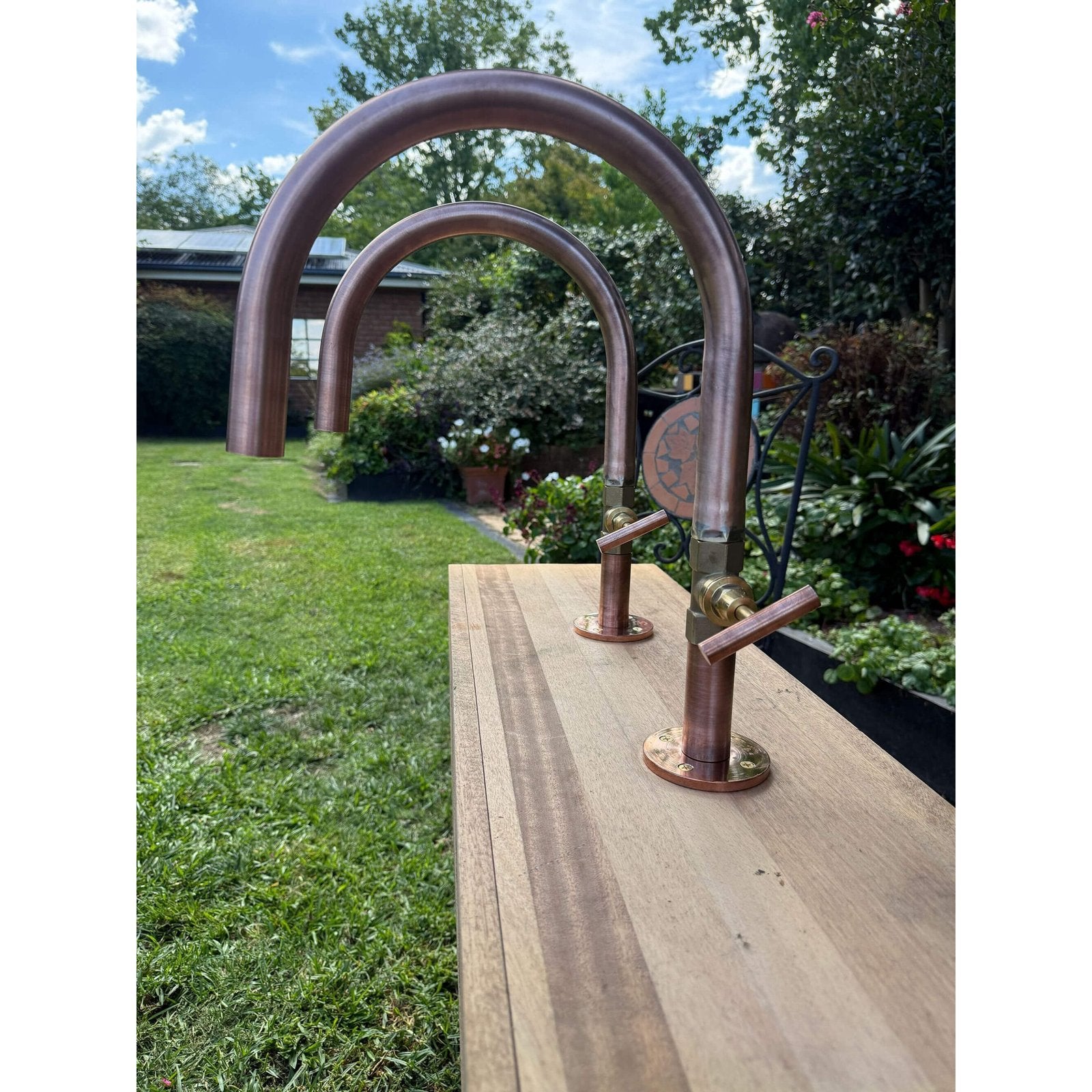 Handmade Hakea 32mm copper bath pillar tap with gooseneck spout.