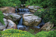 A 5m pondless waterfall built with the Aquascape Medium Pondless Waterfall Kit, cascading over stone into a rock-filled reservoir