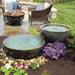 Large Patina spillway bowl and basin fountain in a courtyard garden