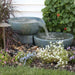 Small Patina spillway bowl and basin fountain in a planted garden
