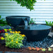 Large Iron Ore spillway bowl and basin fountain installed in a garden