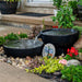 Small Iron Ore spillway bowl spilling into its basin in a garden bed