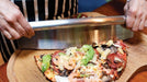 Cutting a pizza with the Buschbeck rocking cutter