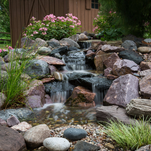 A 2m pondless waterfall stream built with the Aquascape Small Pondless Waterfall Kit, running over rock into a gravel bed
