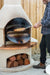 Buschbeck pizza insert in use, pizza going in on a peel