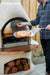 Sliding a pizza into the Buschbeck pizza insert fitted in a Rondo