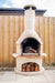 Buschbeck Rondo Outdoor Fireplace lit during the day on a paved patio