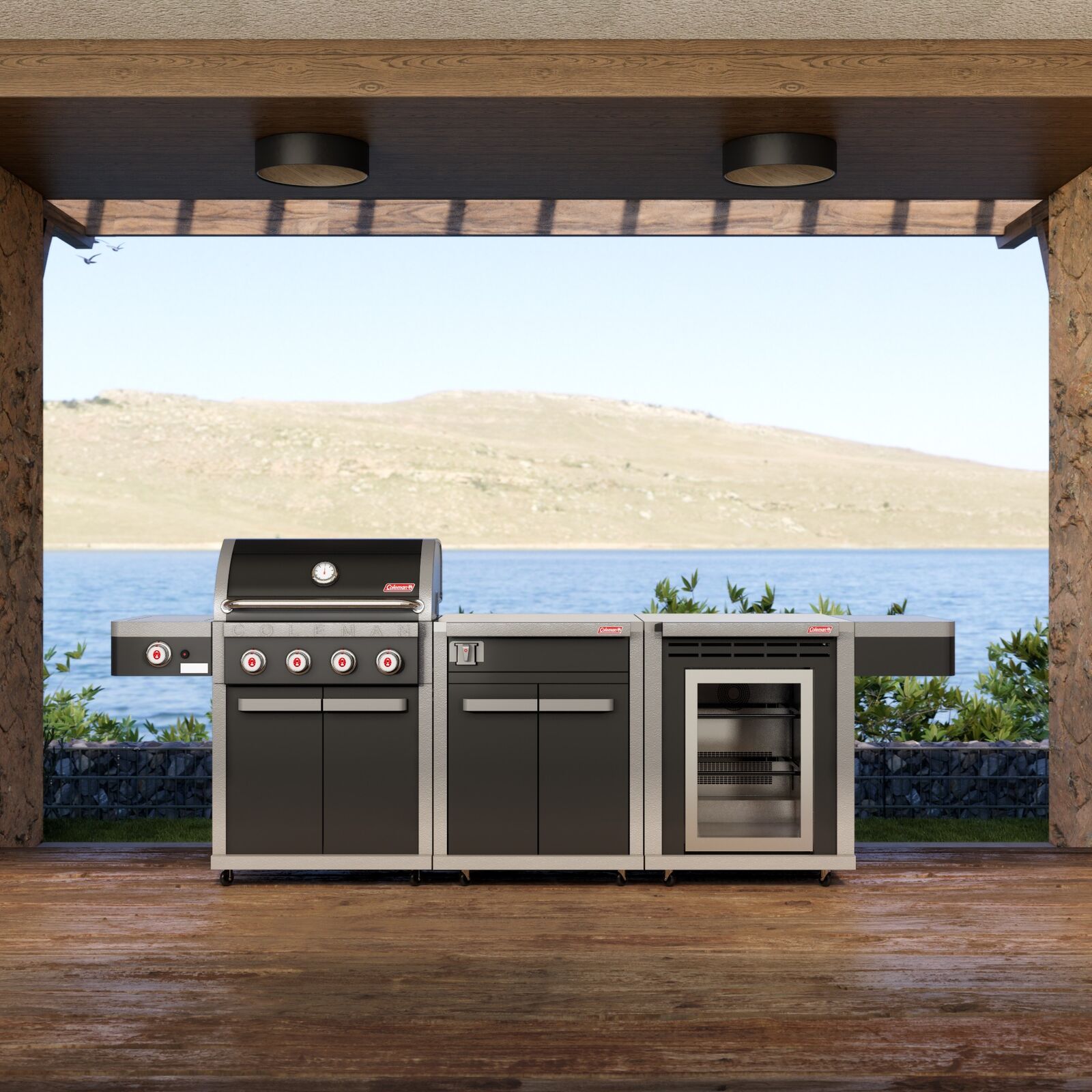 Coleman Revolution 4 Burner outdoor kitchen in Black Gloss on a timber deck under a pergola overlooking water