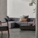 Dash 50 concrete coffee table placed in a contemporary living room with grey sectional sofa and decor.