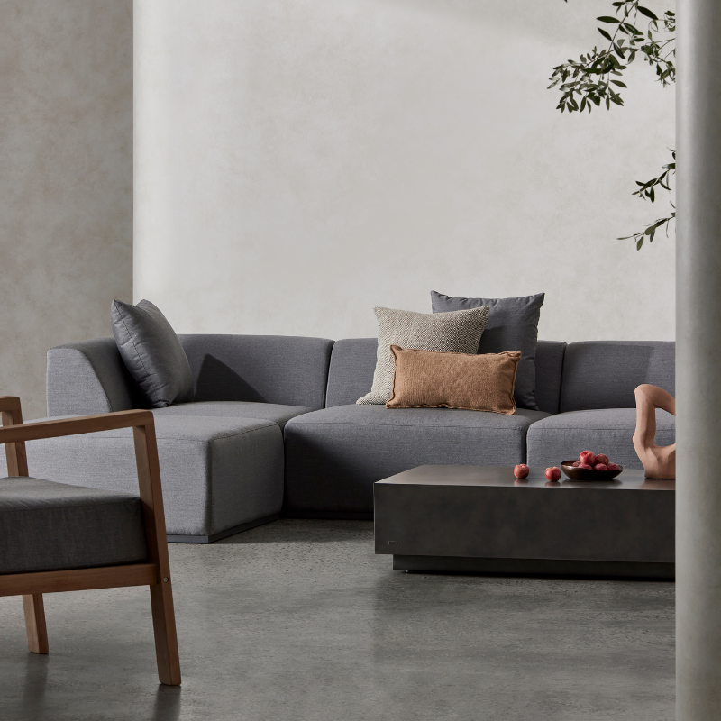 Dash 50 concrete coffee table placed in a contemporary living room with grey sectional sofa and decor.