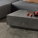 Close-up detail of Dash 50 concrete coffee table surface and edge in a contemporary living room setting.