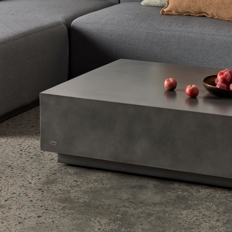 Close-up detail of Dash 50 concrete coffee table surface and edge in a contemporary living room setting.