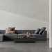 Dash 50 rectangular concrete coffee table in graphite finish styled in a minimalist modern lounge interior.