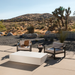 Move 65 rectangular concrete coffee table in outdoor desert landscape patio setting with modern seating