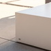 Close-up detail of Move 65 rectangular coffee table in bone white concrete finish on outdoor patio