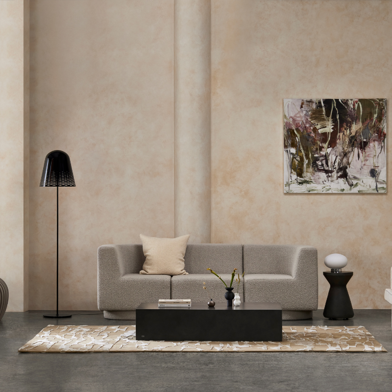 Niche 50 rectangular concrete coffee table styled in a designer living room with rug and lounge seating.