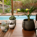Blinde Stitch 100 large concrete planter with tropical plant on a modern outdoor poolside deck