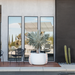 Blinde Stitch 50 white concrete planter with orange stitched rope detail placed outside a modern home with large glass windows