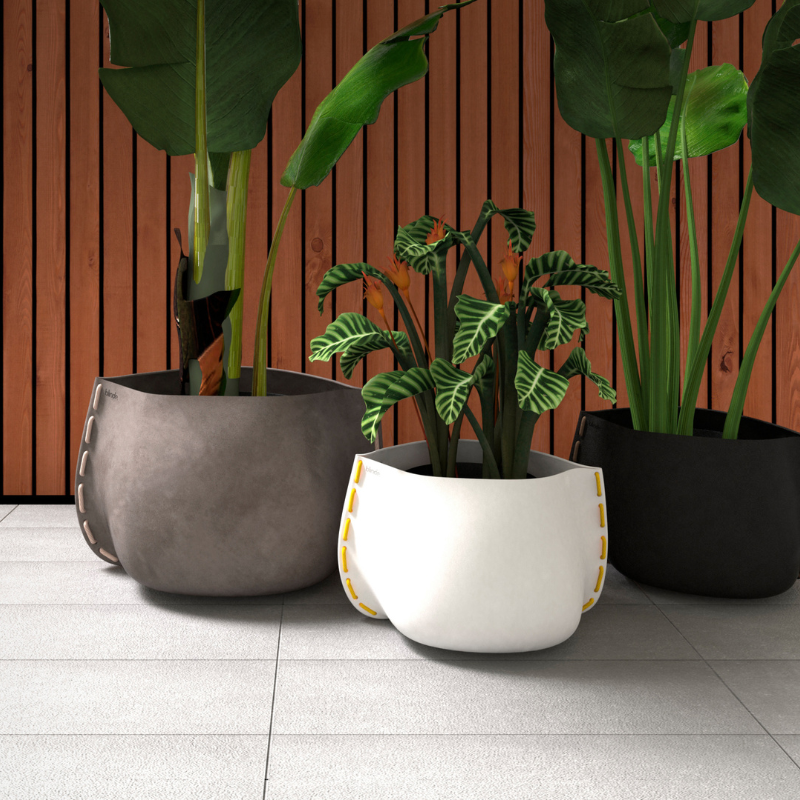 Blinde Stitch concrete planters in white, dark concrete and black finishes with decorative rope stitching displayed with indoor plants