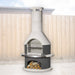 Buschbeck Rondo 3-in-1 outdoor fireplace, BBQ and pizza oven in Grey, with grey firebox, stainless steel shelf insert and wood store, shown in a backyard setting
