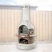 Buschbeck Rondo 3-in-1 outdoor fireplace, BBQ and pizza oven in Mocha, with mocha firebox, copper shelf insert and wood store, shown in a backyard setting
