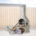 Buschbeck Rondo 3-in-1 outdoor fireplace, BBQ and pizza oven kit in White with the pizza oven door, peels, cutter and base extension, shown in a backyard setting