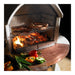 Close-up of the Buschbeck St Moritz chrome cooking grill with vegetables and copper mantle