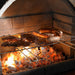 Grilling steak and sausages on the Buschbeck St Moritz at night with a glass of red wine