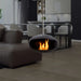 Cocoon Aeris Hanging Bioethanol Fireplace in matt black hanging in a modern apartment lounge
