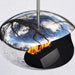 Cocoon Aeris Hanging Bioethanol Fireplace in stainless steel reflecting trees and sky outdoors