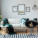 Cocoon Pedestal Bioethanol Fireplace in matt black in a living room beside a cream sofa