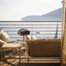Cocoon Pedestal Bioethanol Fireplace in stainless steel on a sheltered terrace above the ocean