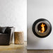 Cocoon Vellum Wall Mounted Bioethanol Fireplace in black on a white wall beside a grey sofa
