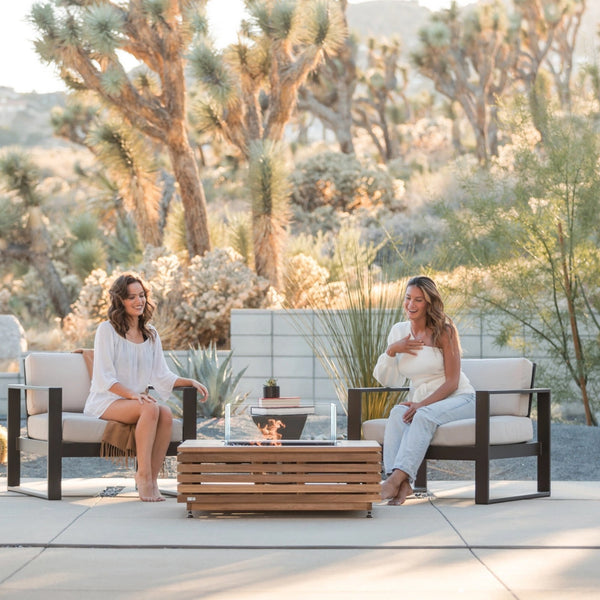 EcoSmart Base 40 fire table on a desert terrace at golden hour with two guests seated by the flame.