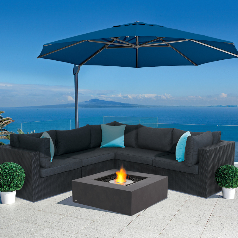 EcoSmart Base 40 fire table on outdoor terrace with sectional seating and ocean view