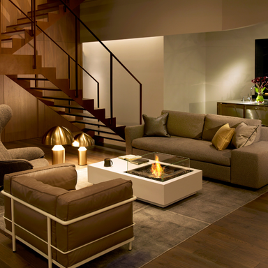 EcoSmart Manhattan 50 fire table in an elegant indoor living room with a live flame from the central bioethanol burner.