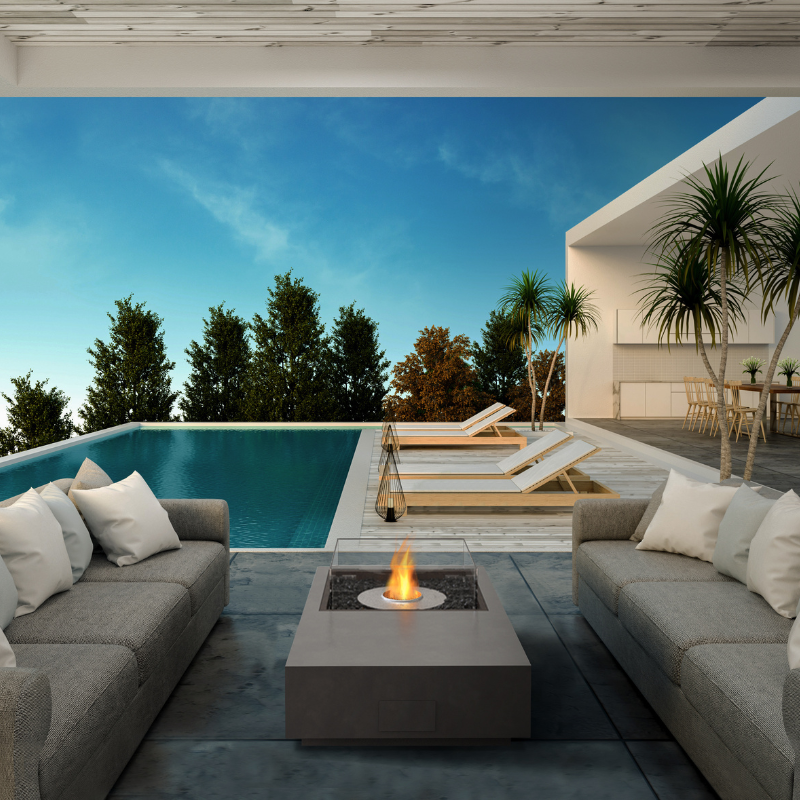 EcoSmart Manhattan 50 fire table on an outdoor poolside lounge setting.