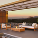 EcoSmart Manhattan 50 fire table at sunset on an outdoor terrace, with a live flame.