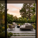EcoSmart Mimosa 40 in a garden setting at sunset, viewed through a doorway with woven outdoor furniture.